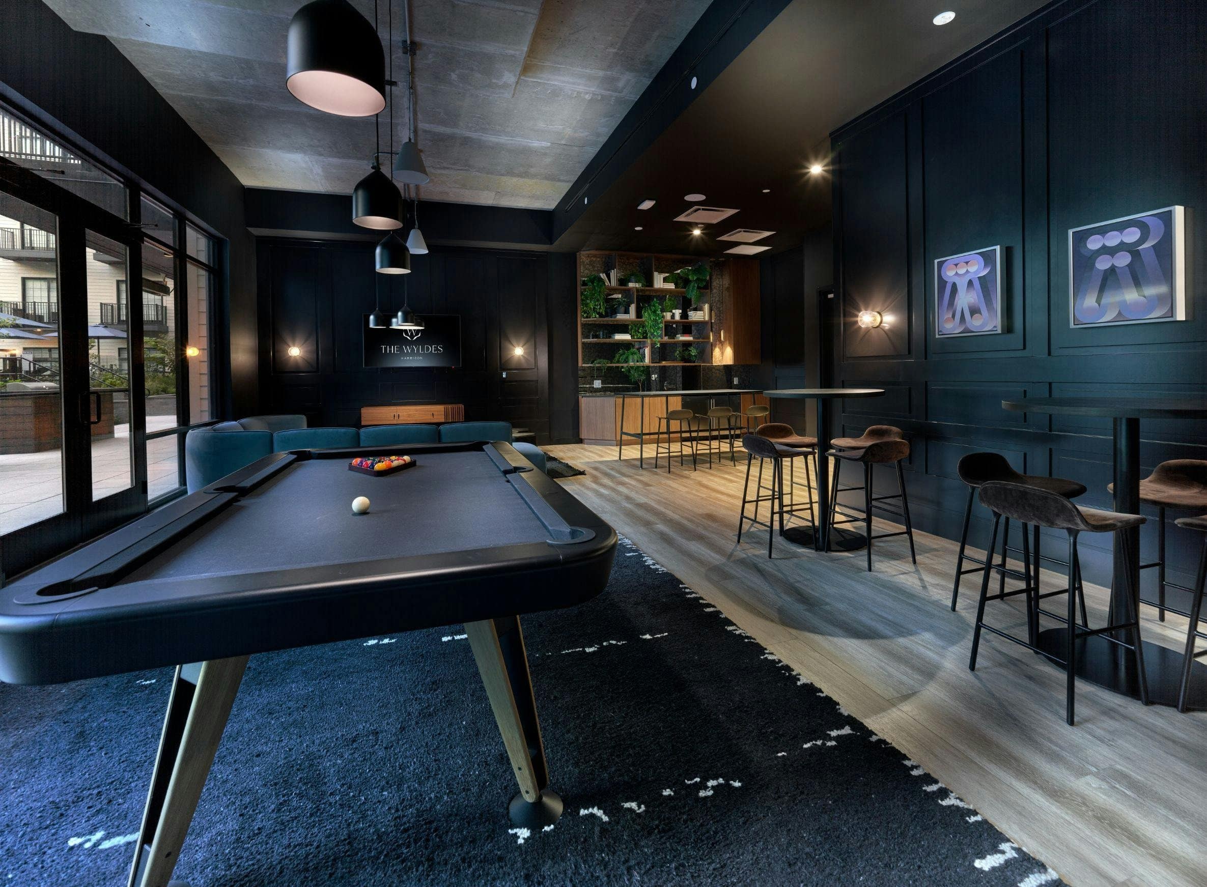 Two small framed works hang beside the billiards table at The Wyldes.