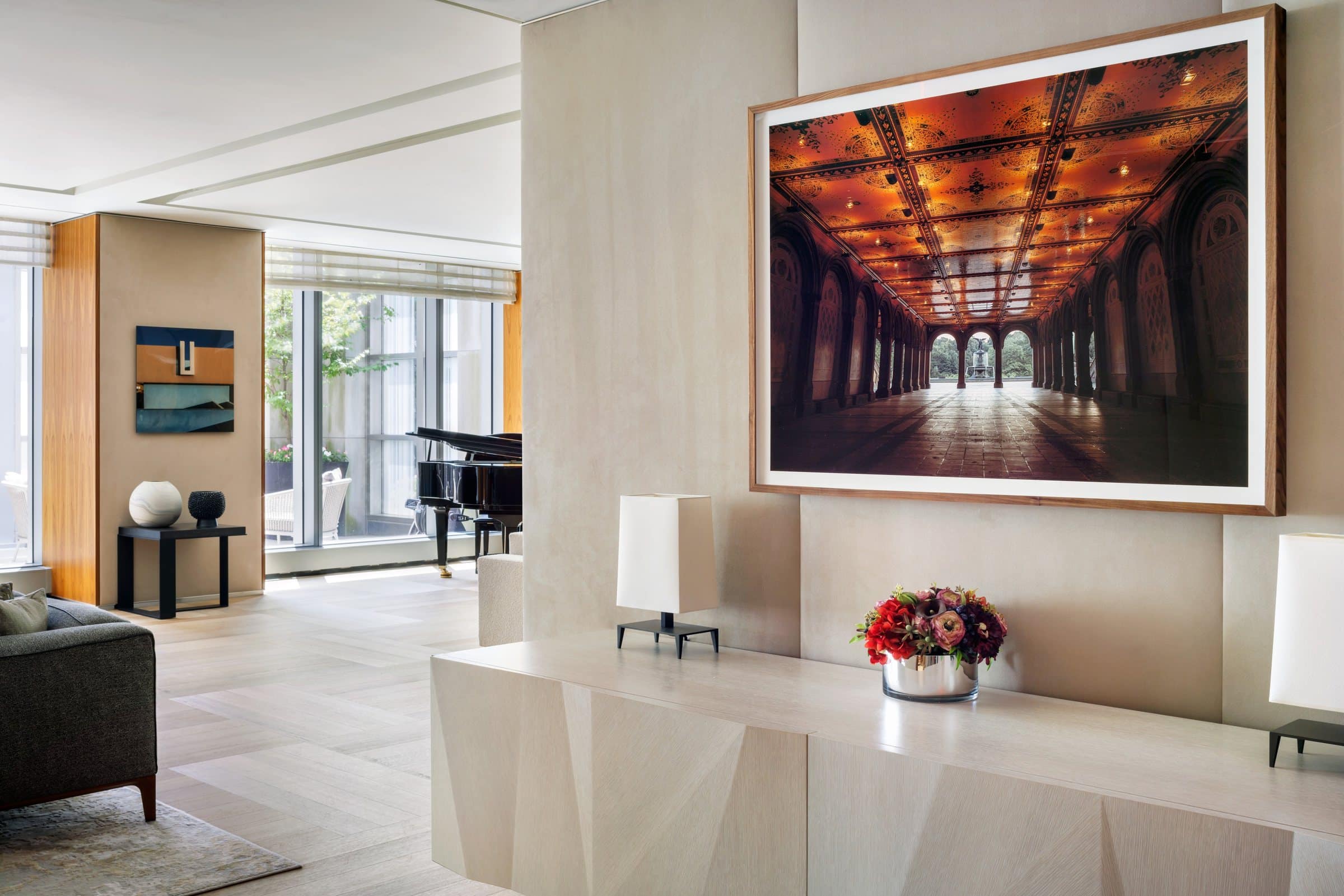 Large photograph of a glowing orange vaulted arcade above a console, with another architectural photograph beyond