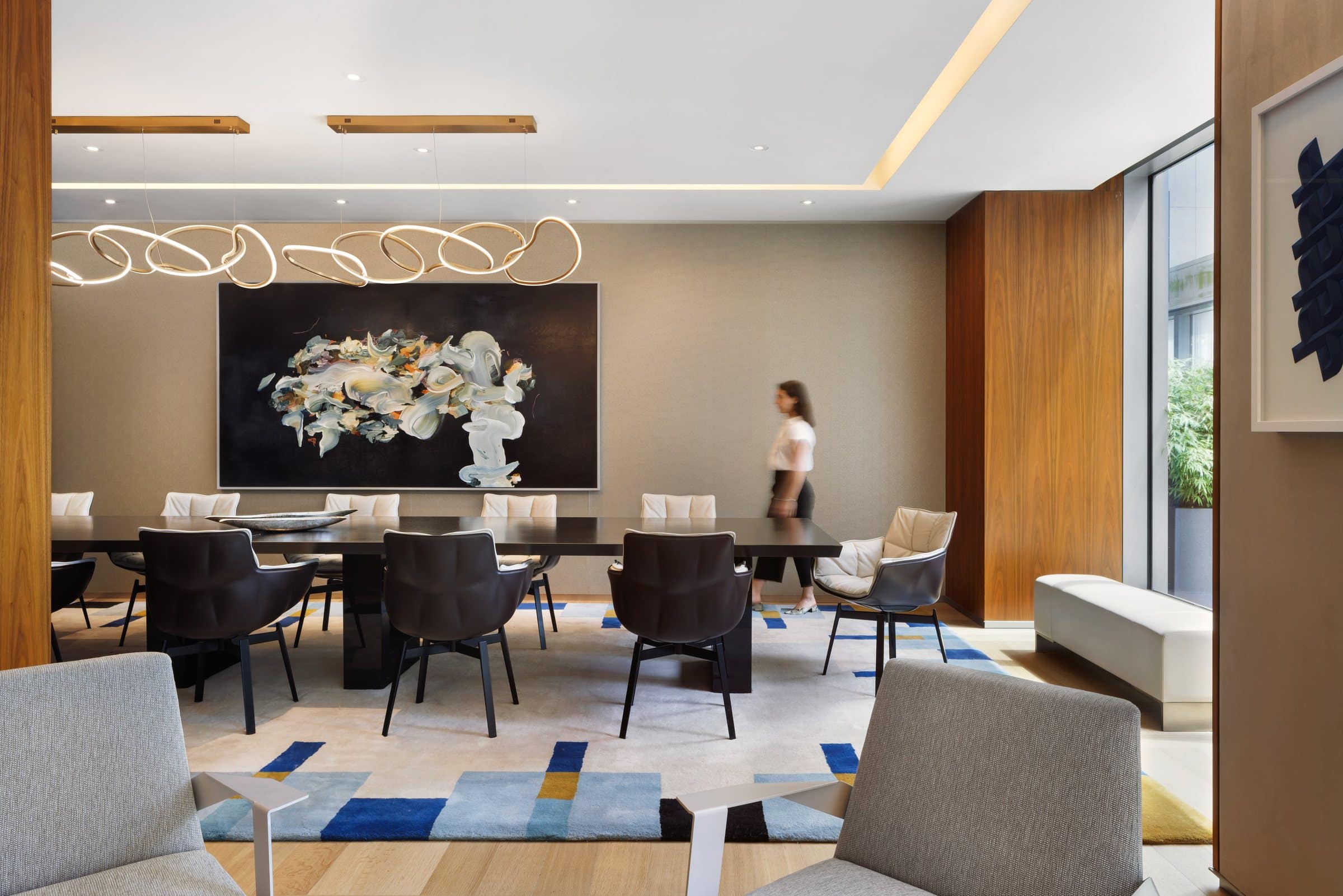 A visitor walks through the dining room beneath the black-ground gestural painting