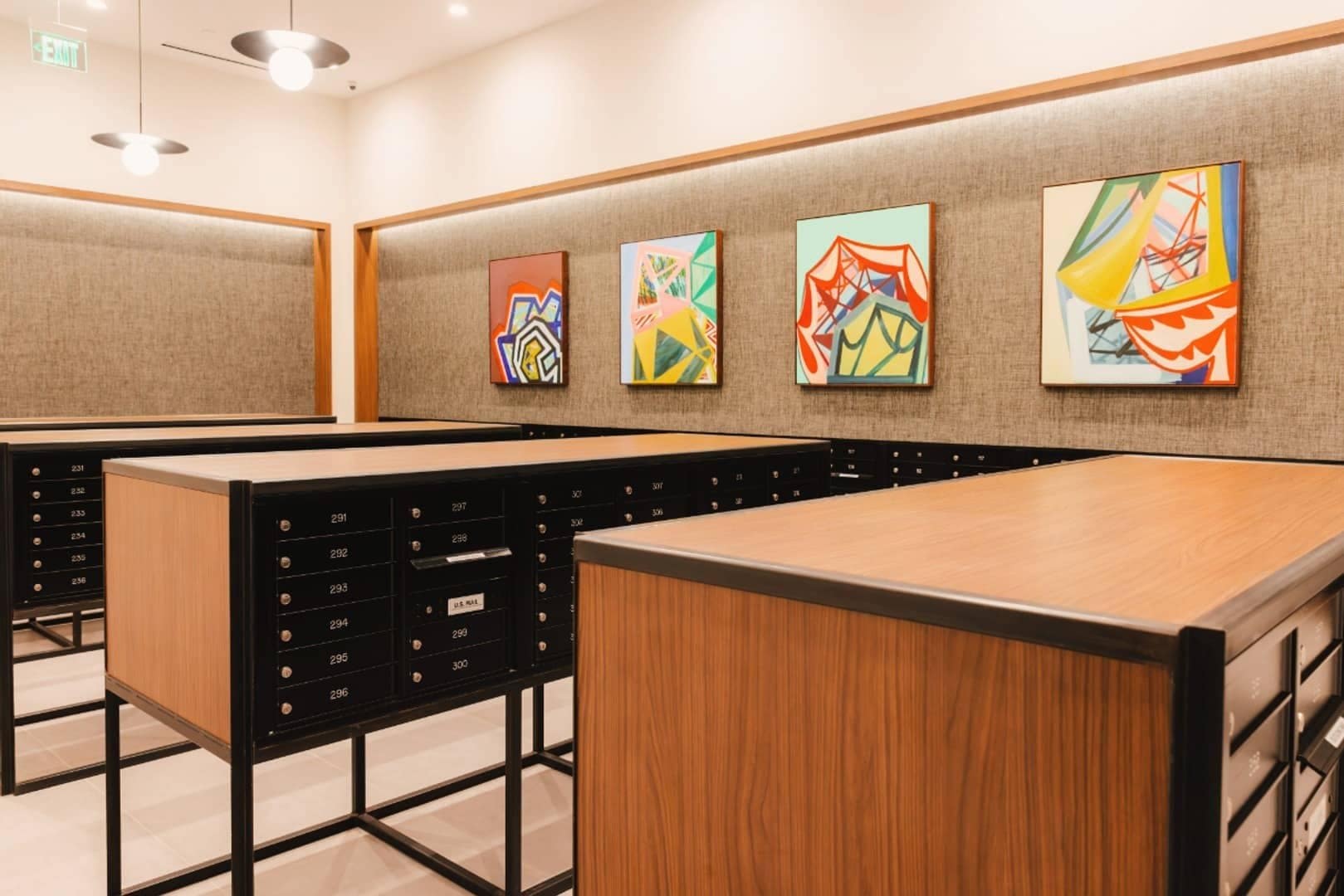 Four brightly colored abstract paintings hang above the mailboxes at Linea.
