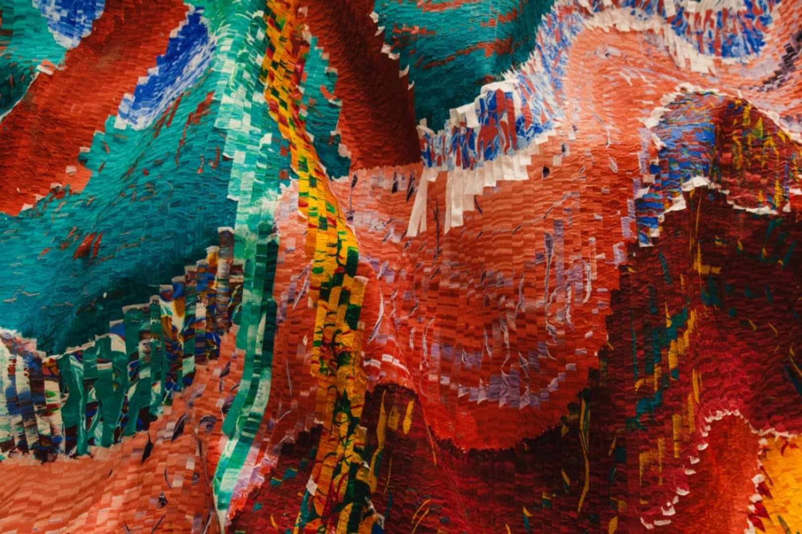 Detail of layered red, turquoise, blue and pale silk strips in the Linea lobby commission.