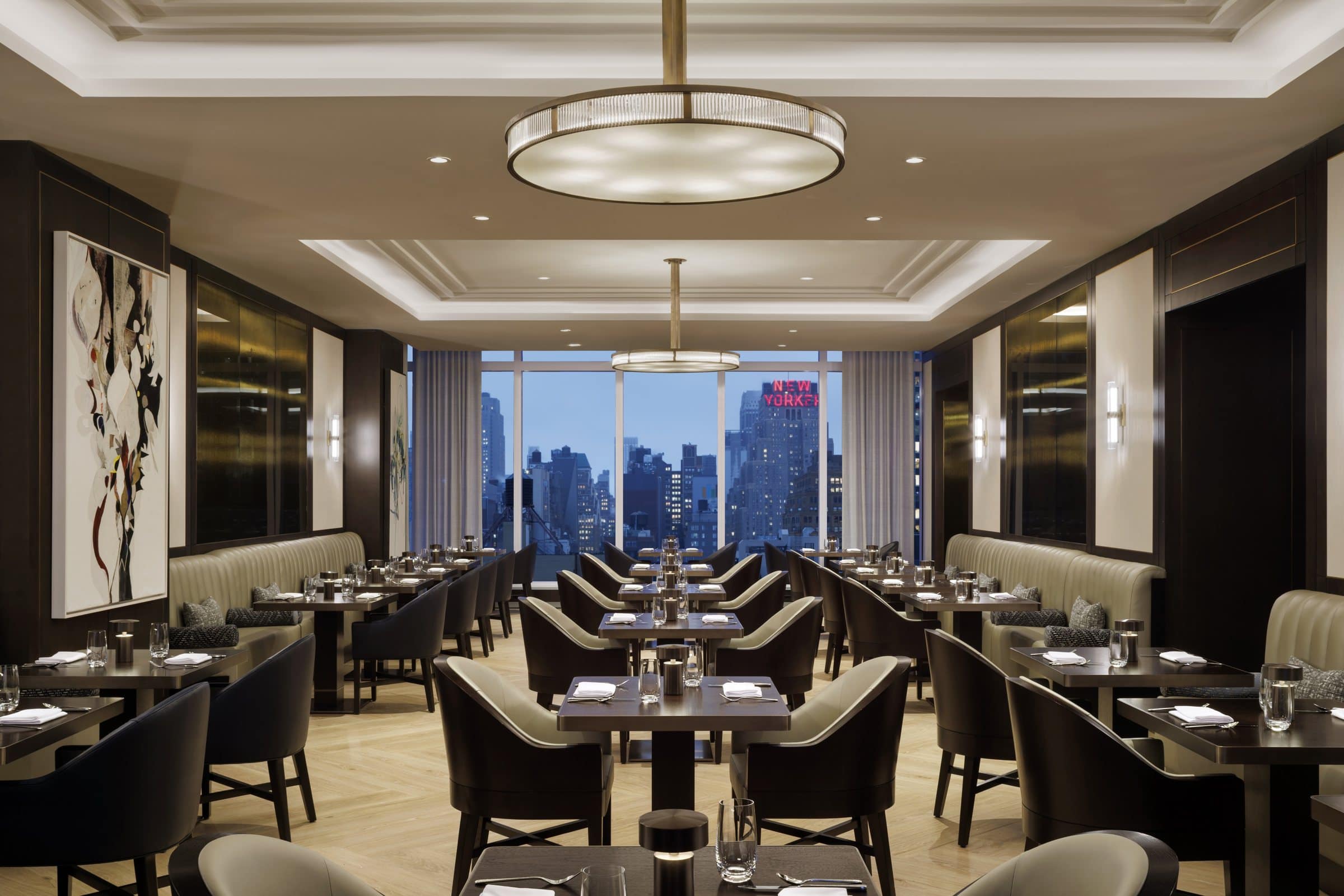 Long dining room overlooking the skyline, with a large white and black gestural canvas on the left wall