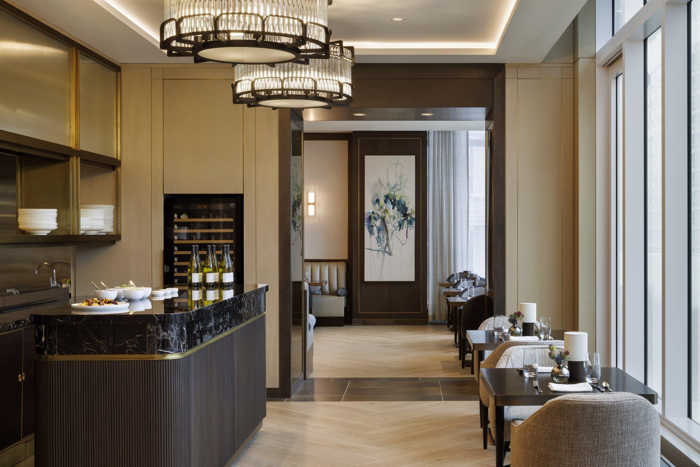 Dining service counter with a dark marble surface, looking toward a tall white and blue abstract painting